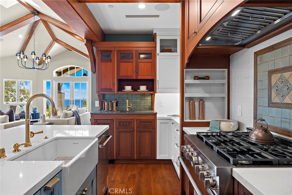 A dedicated bar with custom cabinetry, quartz counters, and a Soft Tetris tile backsplash creates a natural setting for - 3002 Dorn Court, Laguna Beach CA 92651 - photo 12