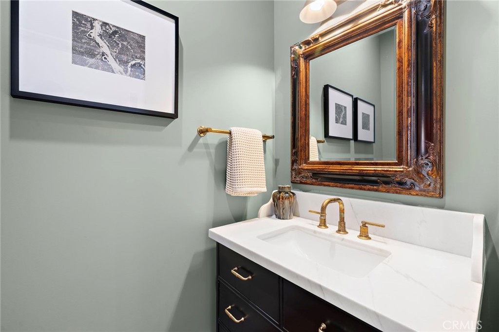 Powder bath located off the living area complete with Toto toilet, Phylrich French Brass faucet and reclaimed Honduras M - 3002 Dorn Court, Laguna Beach CA 92651 - photo 13