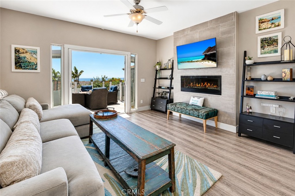 Living room and double doors leading to the oceanview deck - 30802 Coast F25, Laguna Beach CA 92651 - photo 6