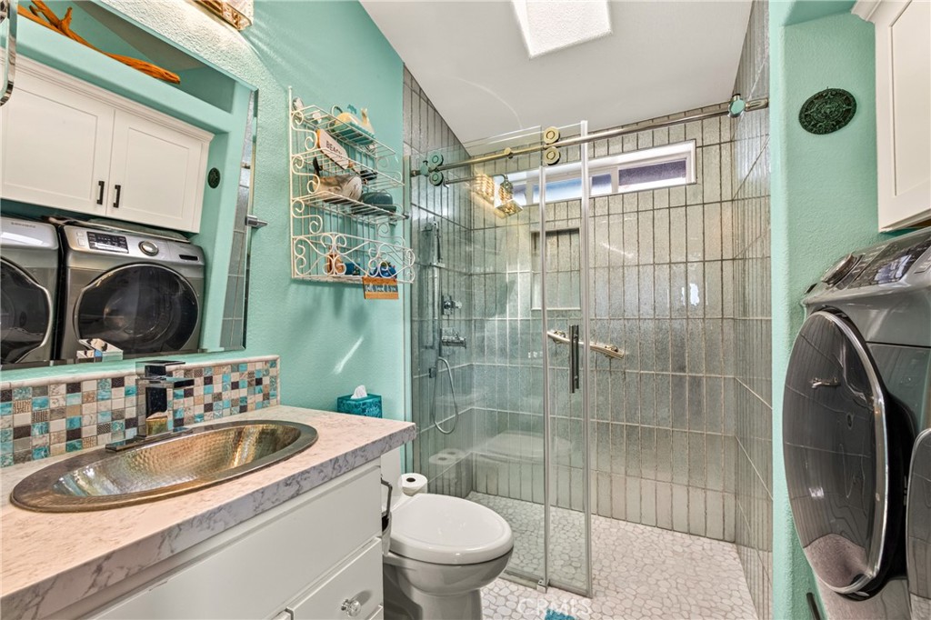 Walk-in shower with barn-style sliding glass door in secondary bath - 30802 S Coast Highway F-10, Laguna Beach CA 92651 - photo 15