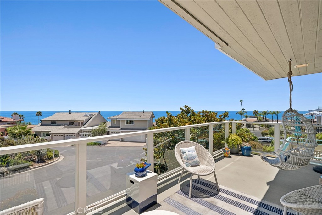 Complete with a wet bar, beverage refrigerator, and French doors opening to an ocean view deck, this inviting space embr - 31012 Aliso Circle, Laguna Beach CA 92651 - photo 3