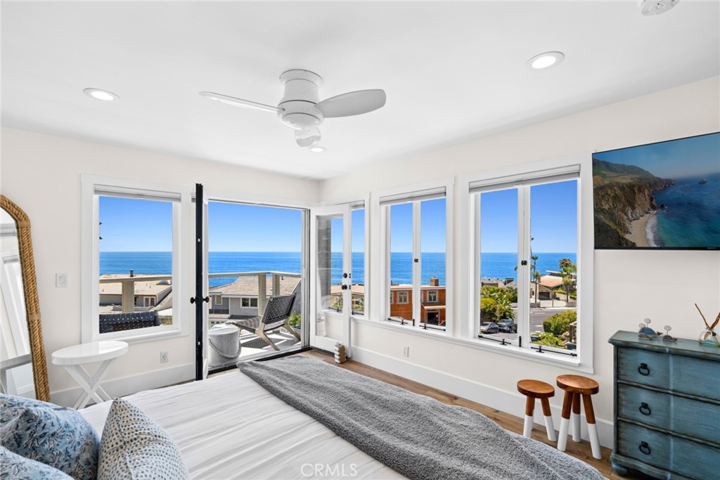 Occupying its own private level, the primary suite is a tranquil retreat with sweeping ocean views, a private viewing de - 31012 Aliso Circle, Laguna Beach CA 92651 - photo 14