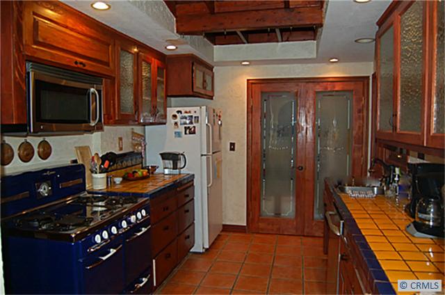 Vintage kitchen with hand painted tile counters, glass front cabinetry. Skylight. - 3110 BONN Drive, Laguna Beach CA 92651 - photo 1