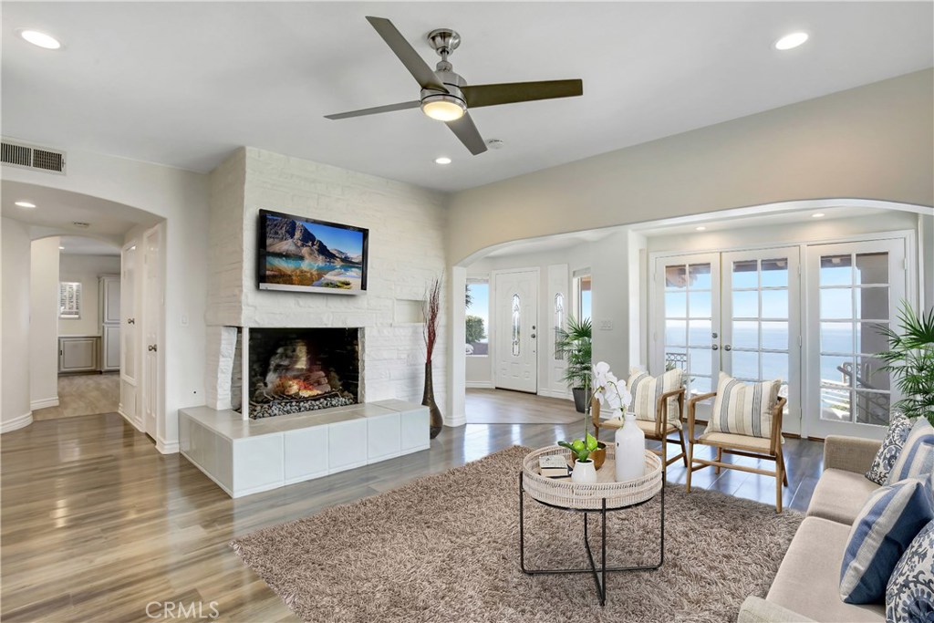 Spacious living room with an abundance of light with stunning ocean and hillside views. - 31122 Brooks Street, Laguna Beach CA 92651 - photo 11