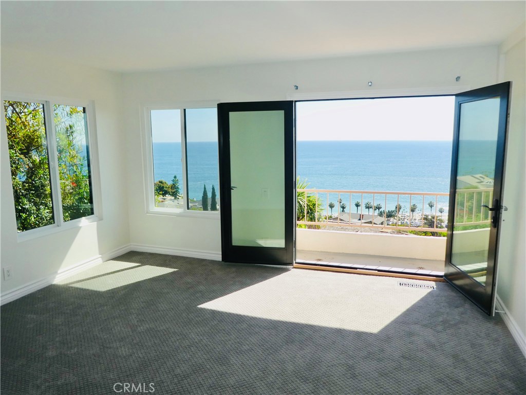 One of two master bedrooms with stunning ocean views. This master features an en suite bath with remodeled shower, priva - 31122 Brooks Street, Laguna Beach CA 92651 - photo 21