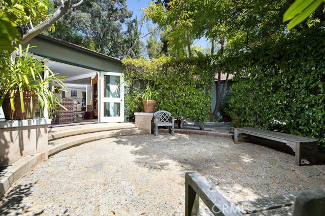 The home provides unique retreats indoors and out, including this front circular patio surrounded by hedges and lush lan - 3120 Bern Drive, Laguna Beach CA 92651 - photo 1