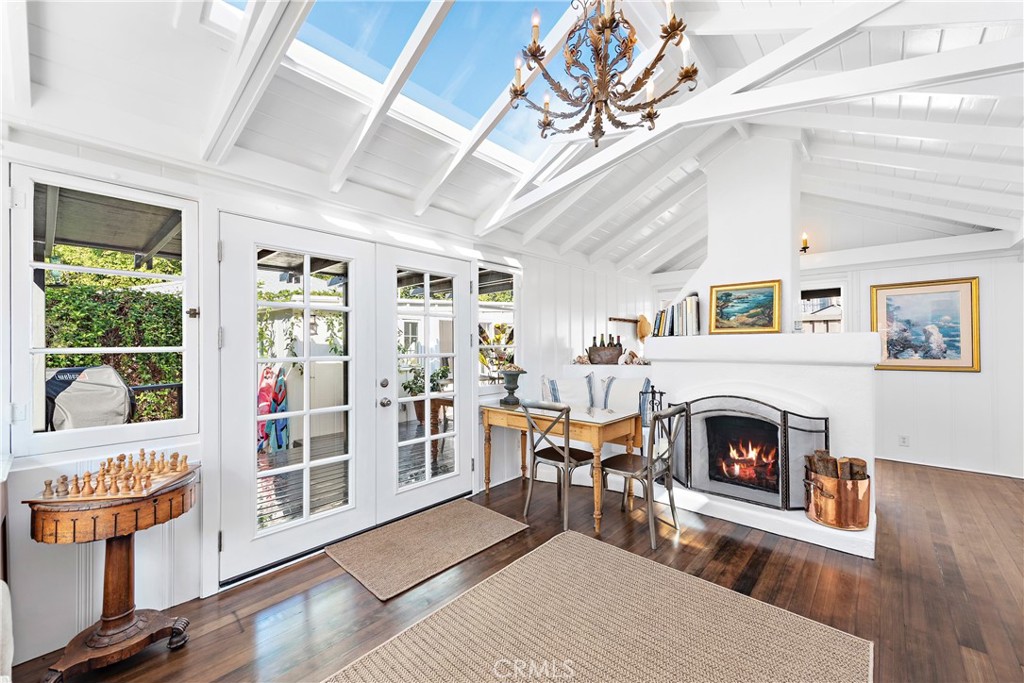 Living room with charming wood burning fireplace. Windows, French doors and retractable skylight bring natural light and - 31521 Summit Road, Laguna Beach CA 92651 - photo 1