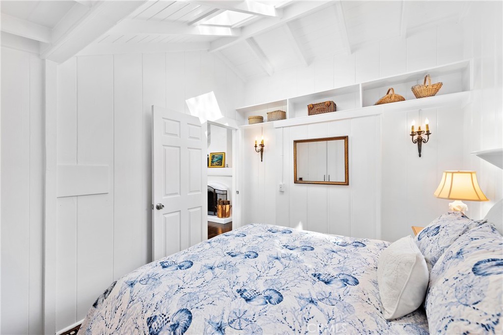 Bedroom in the main cottage with door out to the living room. Sweet built in accents and vintage light fixtures. - 31521 Summit Road, Laguna Beach CA 92651 - photo 14
