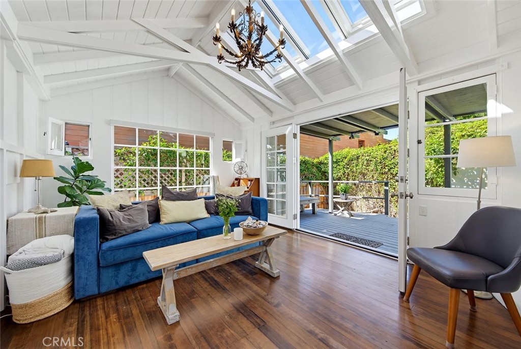 Living room with newer retractable skylights. French doors open onto the covered deck. - 31521 Summit Road, Laguna Beach CA 92651 - photo 12