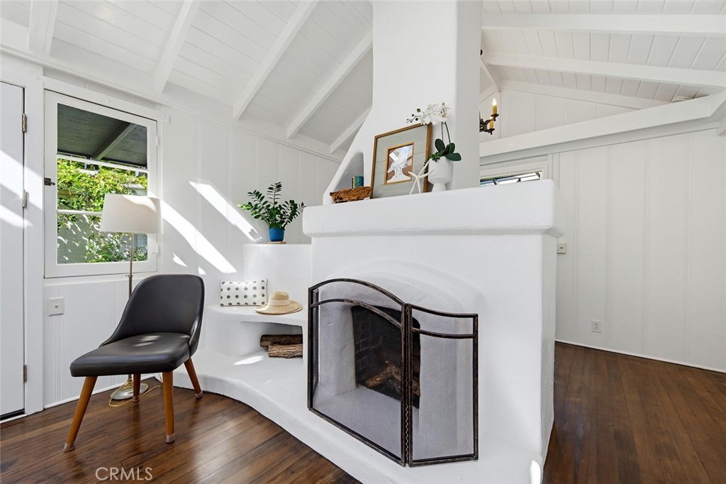 The wood burning fireplace with a gas key is an architectural focal point in the living room. Notice the built in bench - 31521 Summit Road, Laguna Beach CA 92651 - photo 15