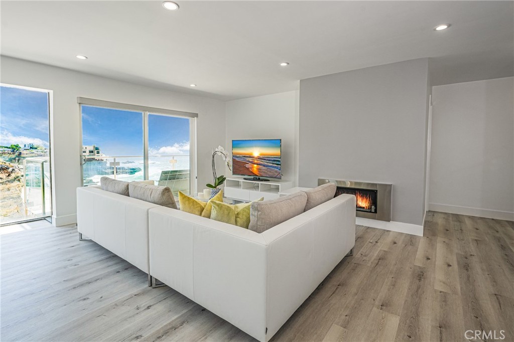 Fire in the fireplace virtually staged. - 31561 Table Rock Drive 102, Laguna Beach CA 92651 - photo 1