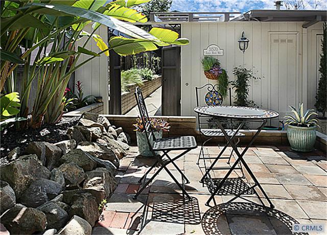 Front elevated patio looking thru the gated front entry. Take trolley down town in the summer just steps away. - 31570 EAGLE ROCK WAY, Laguna Beach CA 92651 - photo 1