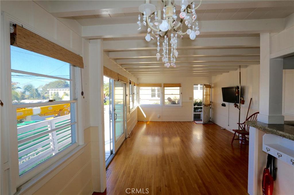 Open floor plan with windows throughout offering plenty of bright light, wood beamed ceilings and hardwood floors - 31662 Fairview Road, Laguna Beach CA 92651 - photo 1