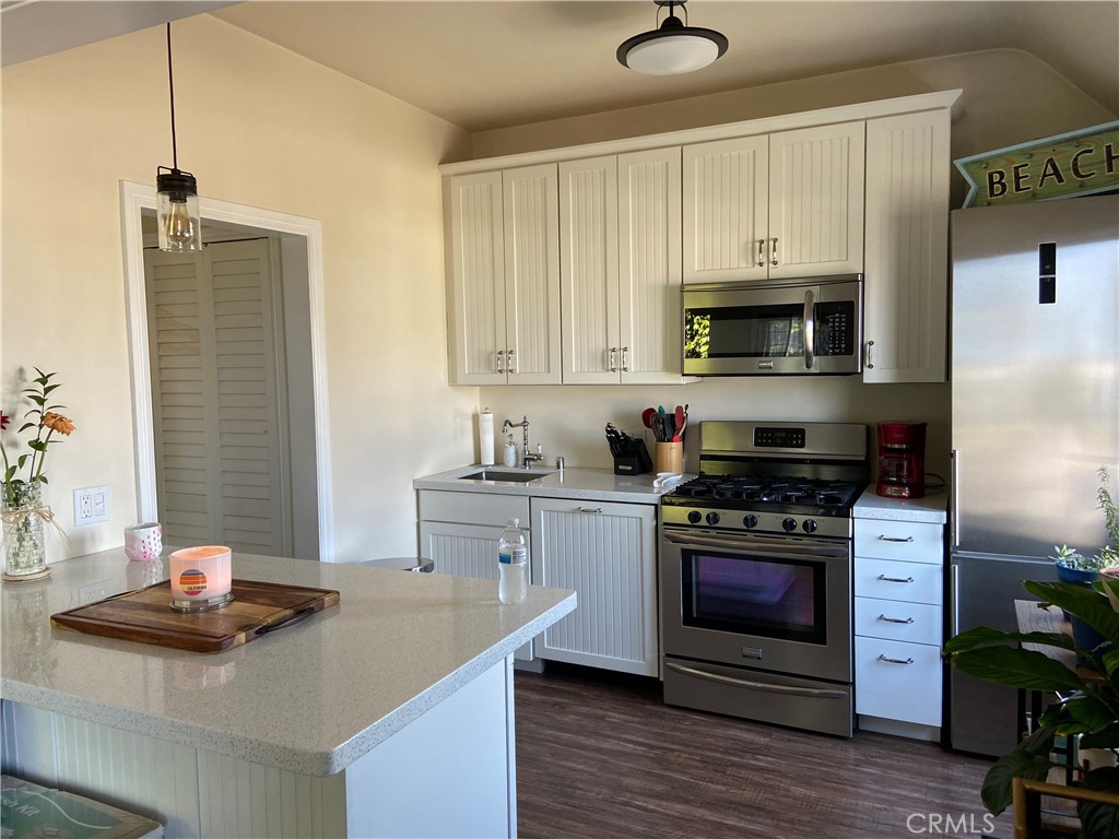 Beautifully remodeled and updated kitchen with new cabinets and stainless steel appliances, built in microwave. - 31672 Coast B, Laguna Beach CA 92651 - photo 1