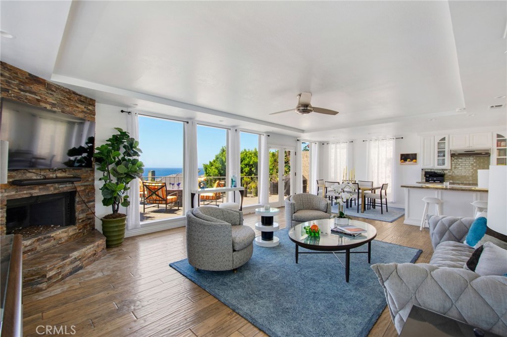 View from main front door entry area towards living and dining room area with stacked-stoned fireplace, large windows wi - 31731 Seacove, Laguna Beach CA 92651 - photo 13