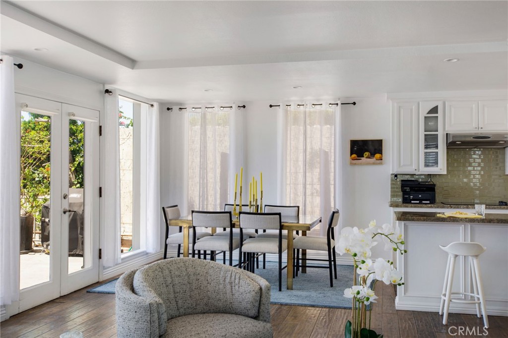 View of open concept living and dining room space with French door direct access to patio. - 31731 Seacove, Laguna Beach CA 92651 - photo 23