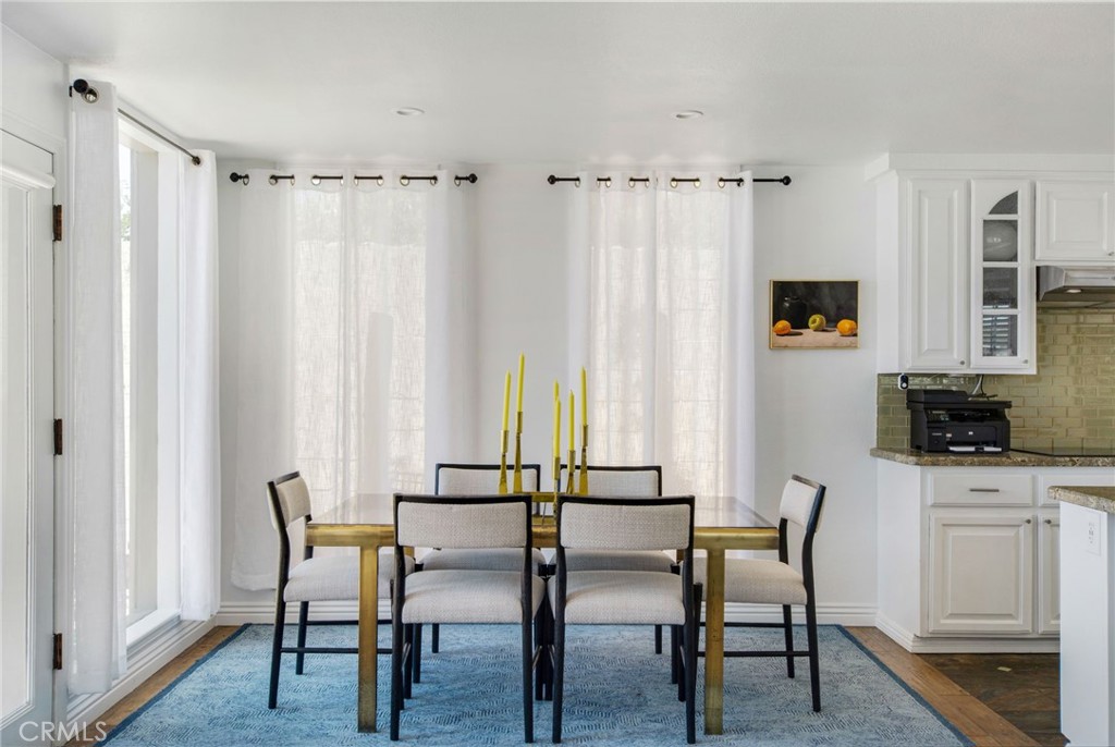 Dining area adjacent to open kitchen and large windows to allow for abundant natural light. - 31731 Seacove, Laguna Beach CA 92651 - photo 28