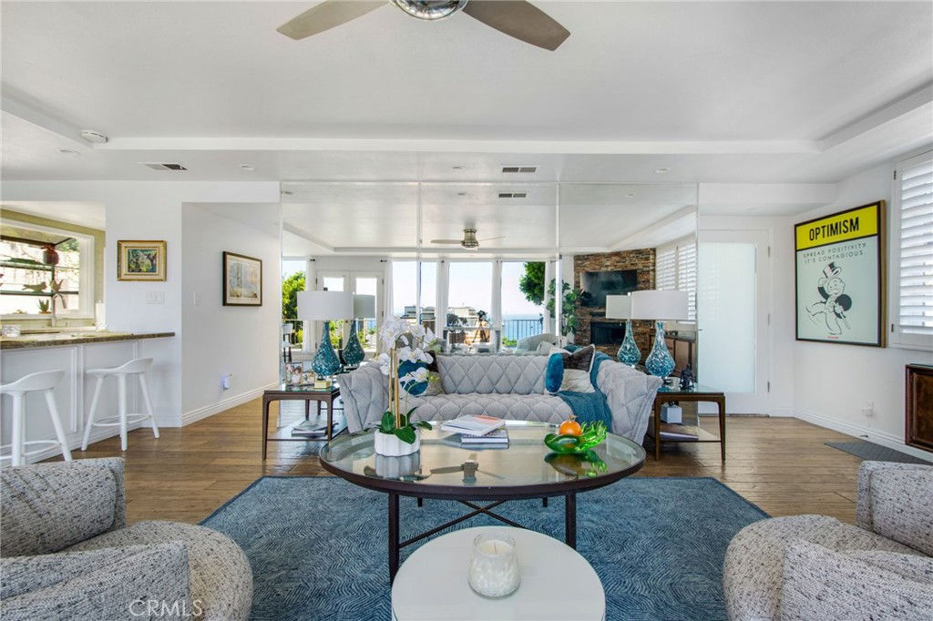 View of living space from back patio with large wall mirrors, front entry frosted glass door and hallway into bedrooms a - 31731 Seacove, Laguna Beach CA 92651 - photo 29
