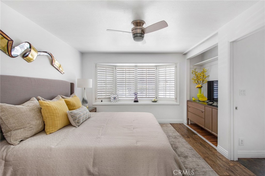 Primary bedroom including ceiling fan w/light, plantation shutters, set within a recessed opening with a built-in window - 31731 Seacove, Laguna Beach CA 92651 - photo 35