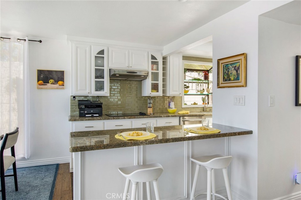 View of updated kitchen with spacious breakfast bar adjacent to dining area. - 31731 Seacove, Laguna Beach CA 92651 - photo 37