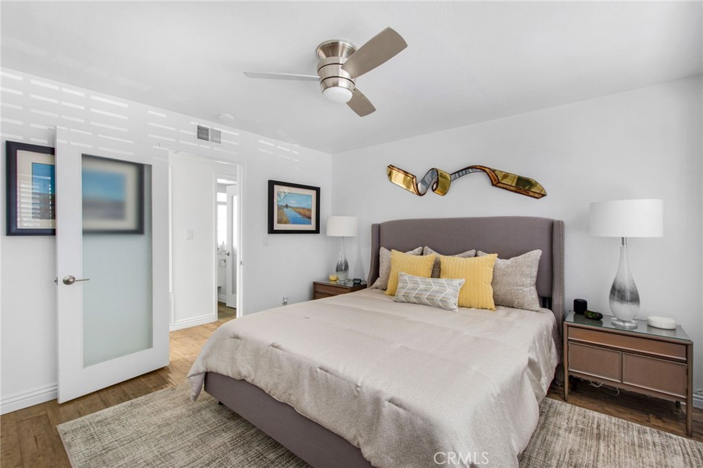 Primary bedroom with frosted glass door and ceiling fan w/light. - 31731 Seacove, Laguna Beach CA 92651 - photo 40