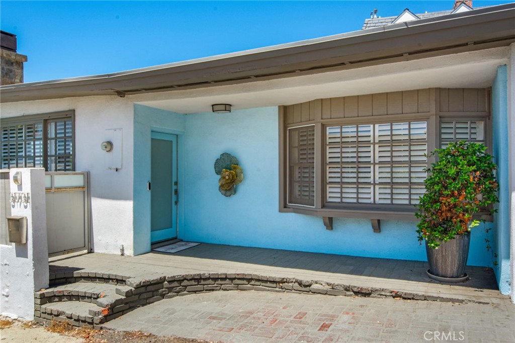Covered front entry, frosted glass main door entry, bay window with plantation shutters and private gated access to pool - 31731 Seacove, Laguna Beach CA 92651 - photo 53