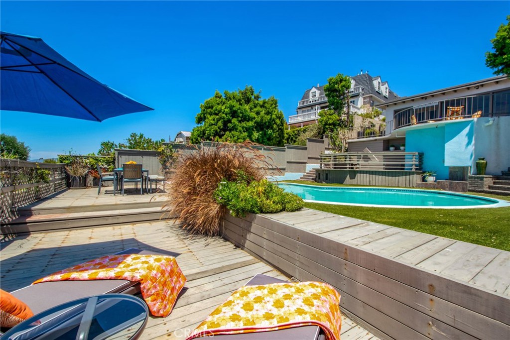 Outdoor entertaining area featuring a private swimming pool, spacious multi-level deck, lounge and dining areas. - 31731 Seacove, Laguna Beach CA 92651 - photo 62