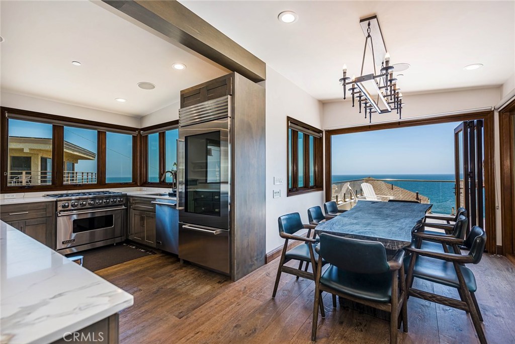 Gourmet kitchen with stainless steel Viking appliances and wine frig. Dining room with folding accordion style doors inc - 31871 Circle Drive, Laguna Beach CA 92651 - photo 1