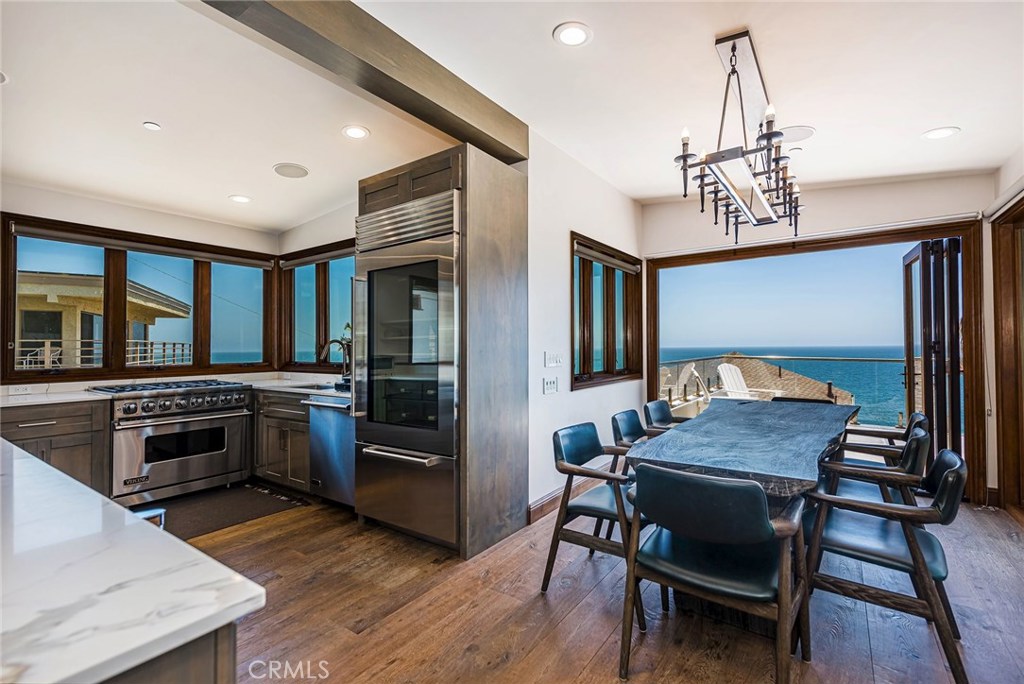 Gourmet kitchen with stainless steel Viking appliances and wine frig. Dining room with folding accordion style doors inc - 31871 Circle Drive, Laguna Beach CA 92651 - photo 1