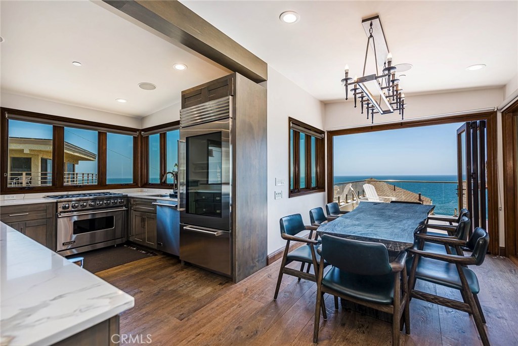 Gourmet kitchen with stainless steel Viking appliances and wine frig. Dining room with folding accordion style doors inc - 31871 Circle Drive, Laguna Beach CA 92651 - photo 1
