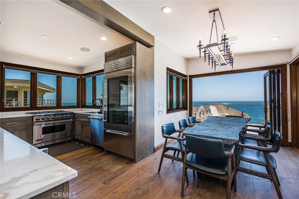 Gourmet kitchen with stainless steel Viking appliances and wine frig. Dining room with folding accordion style doors inc - 31871 Circle Drive, Laguna Beach CA 92651 - photo 1