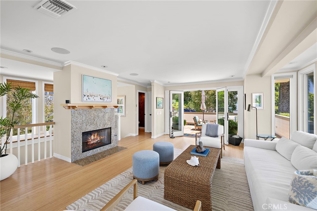 Living room with gas fireplace with granite surround. - 31953 10th Avenue, Laguna Beach CA 92651 - photo 8