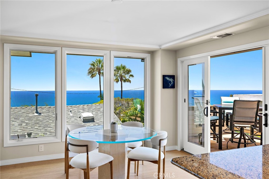 Dining area located off the living room and kitchen, with french doors leading to the second ocean view deck. - 31953 10th Avenue, Laguna Beach CA 92651 - photo 11