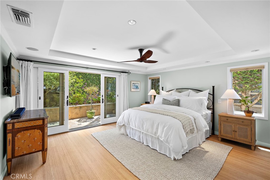 Primary suite offering private outdoor access with a walk-in closet and en-suite bath. - 31953 10th Avenue, Laguna Beach CA 92651 - photo 24