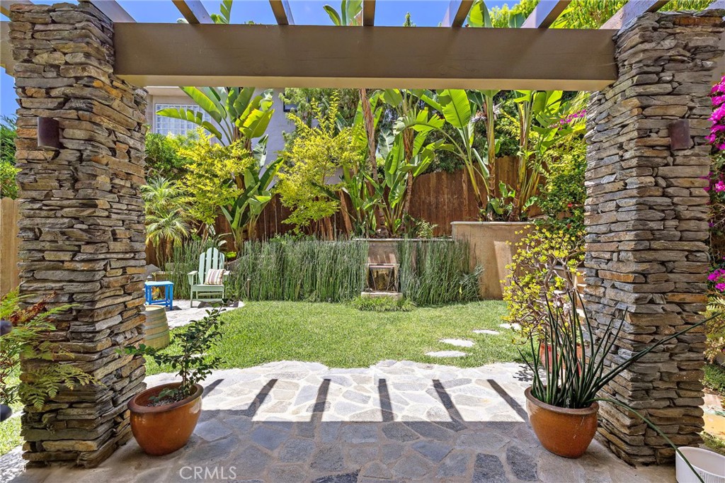 The fully fenced grassy backyard provides a rare expanse of usable outdoor space. - 31953 10th Avenue, Laguna Beach CA 92651 - photo 36