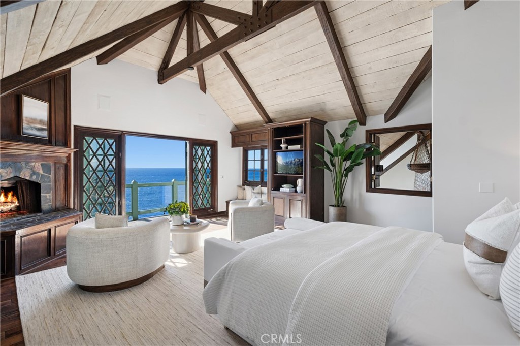 The primary suite offers a private ocean-view deck, fireplace, dual baths, and a walk-in closet—a serene retreat overloo - 31971 Coast Highway, Laguna Beach CA 92651 - photo 20