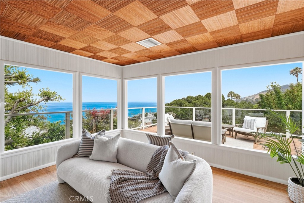 Ocean, city lights, panoramic views, hills and trees at Living room - 32021 & 32001 sunset Avenue, Laguna Beach CA 92651 - photo 9