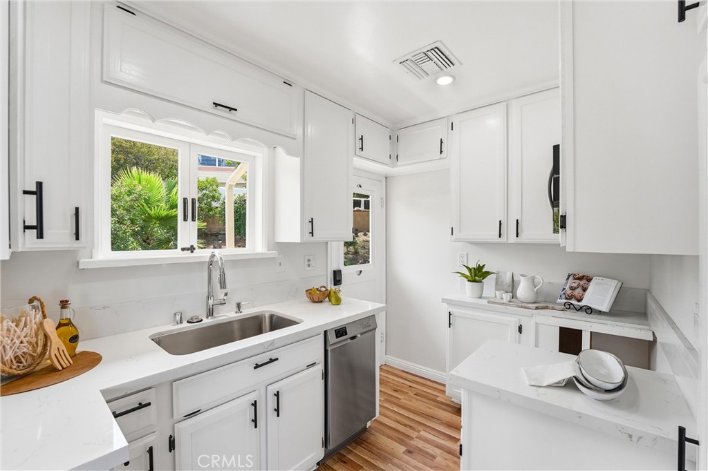 Upgraded new remodeled kitchen with quartz countertops and backsplash, new microwave, dishwasher, floorings etc. - 32021 & 32001 sunset Avenue, Laguna Beach CA 92651 - photo 12