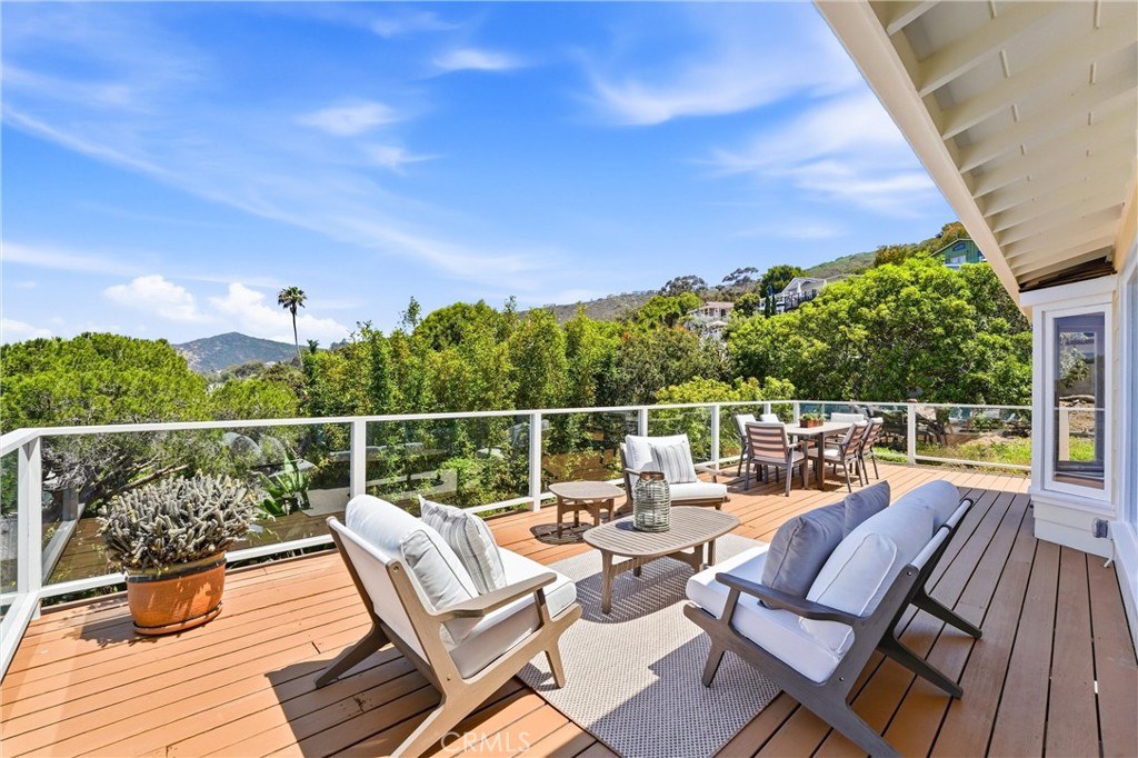 main level large balcony with ocean, hills and tree views, nice, peaceful and private, direct access from dining room an - 32021 & 32001 sunset Avenue, Laguna Beach CA 92651 - photo 17