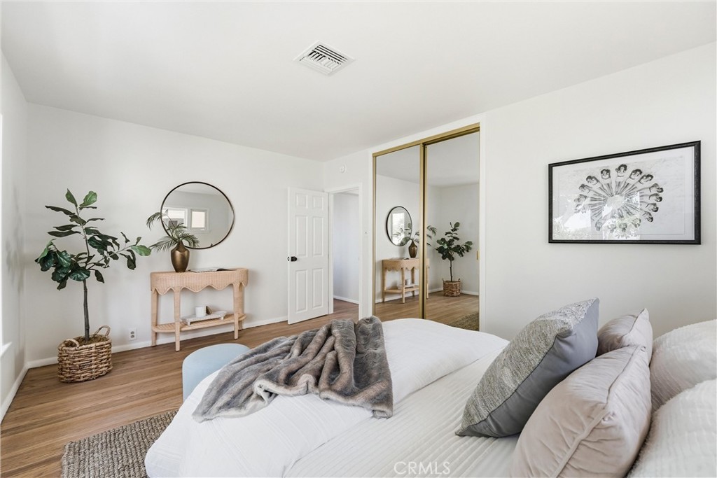Main bedroom with mirrored closet doors, partial ocean views - 32021 & 32001 sunset Avenue, Laguna Beach CA 92651 - photo 21