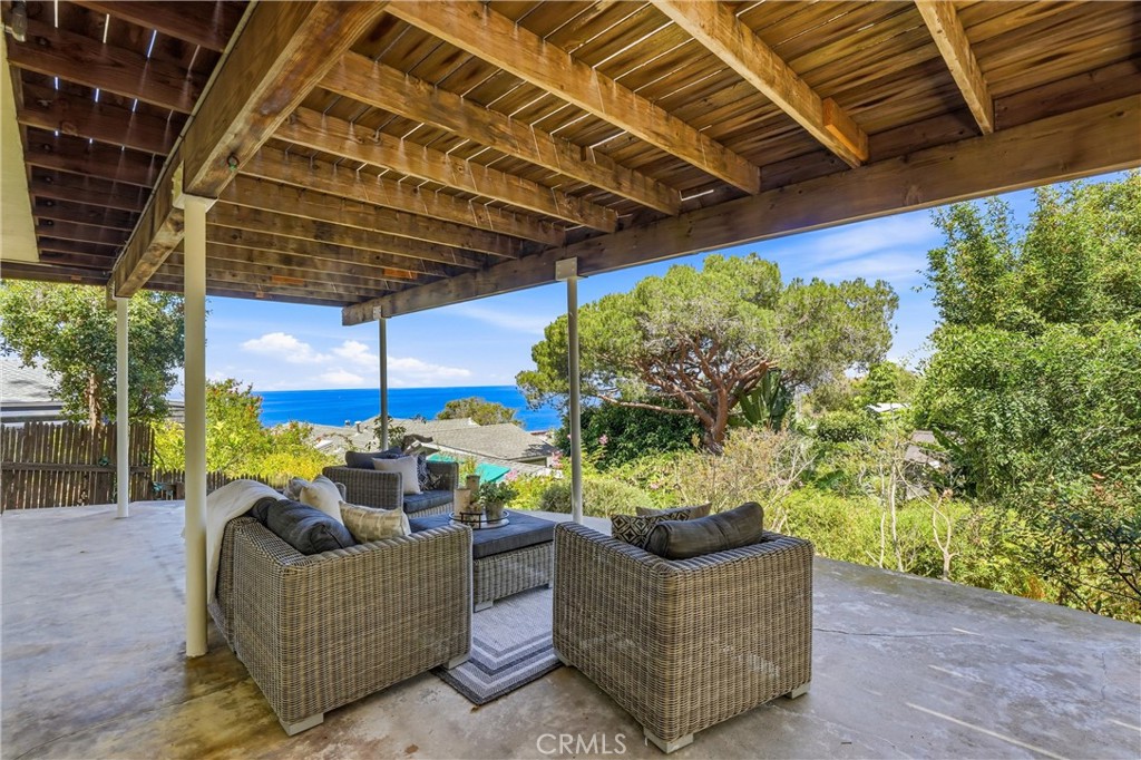 Lower deck/patio with ocean views, Japanese garden, backyard and trees - 32021 & 32001 sunset Avenue, Laguna Beach CA 92651 - photo 32