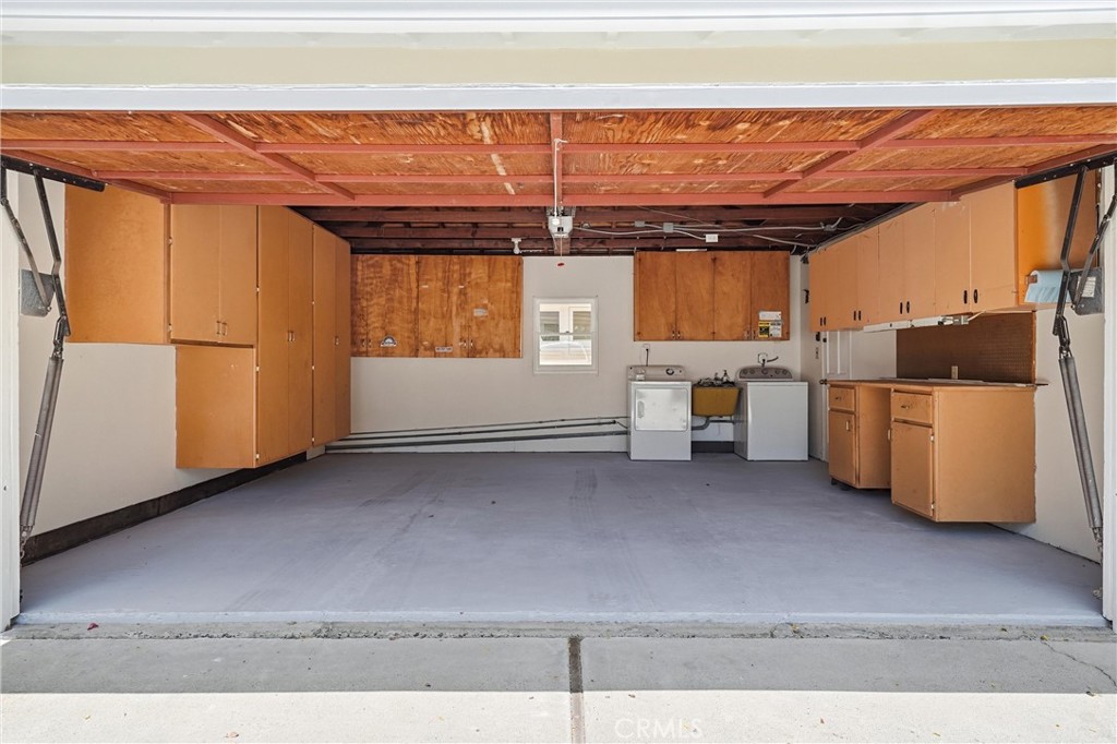 2 Car garage with washer, dryer sink and lots of built in cabinets plus auto opener - 32021 & 32001 sunset Avenue, Laguna Beach CA 92651 - photo 36