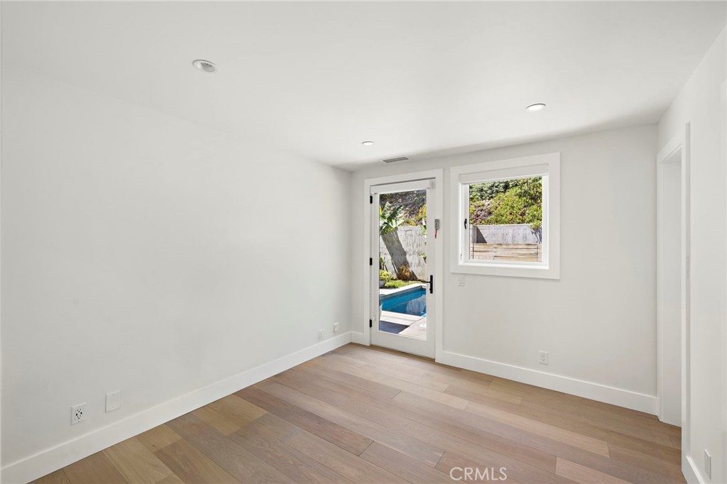 Lower level bedroom with en-suite bath and door that opens to the pool back yard - 3203 Tyrol Drive, Laguna Beach CA 92651 - photo 15