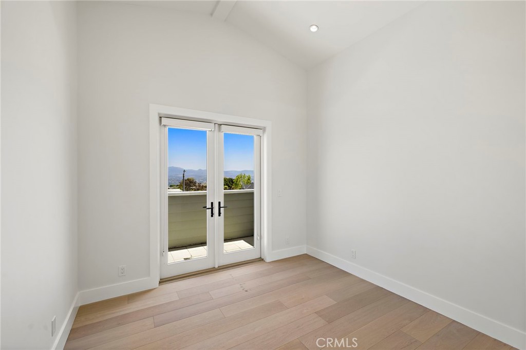 Upstairs guest bedroom with vaulted ceilings and private balcony - 3203 Tyrol Drive, Laguna Beach CA 92651 - photo 27
