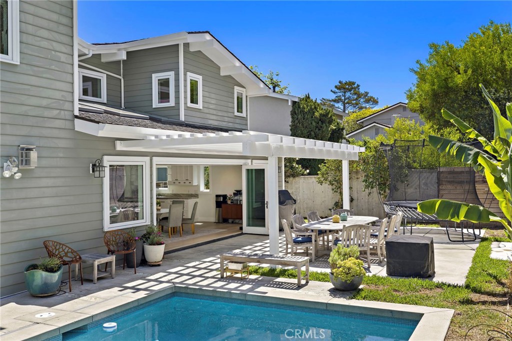 A covered patio offers generous space for gatherings, while a saltwater pool and spa complete the outdoor setting - 3203 Tyrol Drive, Laguna Beach CA 92651 - photo 33