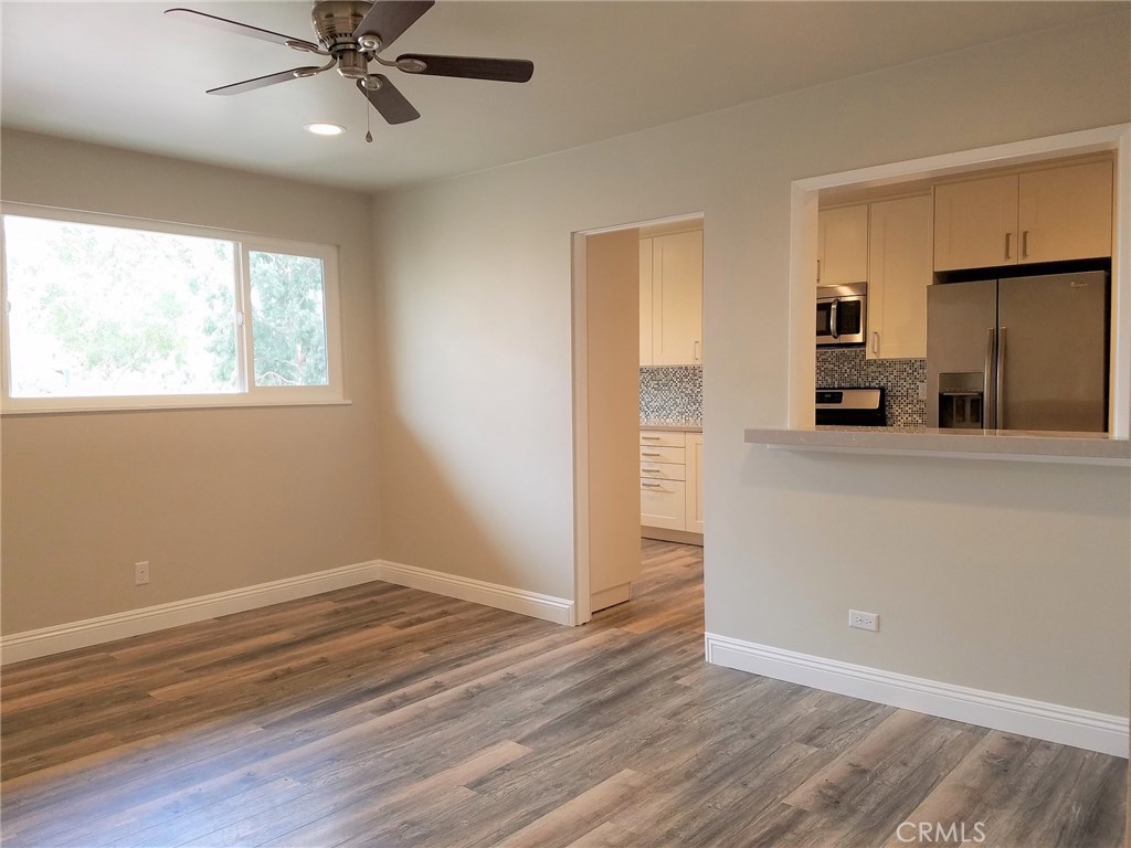 Beautiful living room with brand-new laminate flooring, ceiling fan, and CAT 5 wiring for cable, internet, and TV. - 331 3rd Street A, Laguna Beach CA 92651 - photo 1
