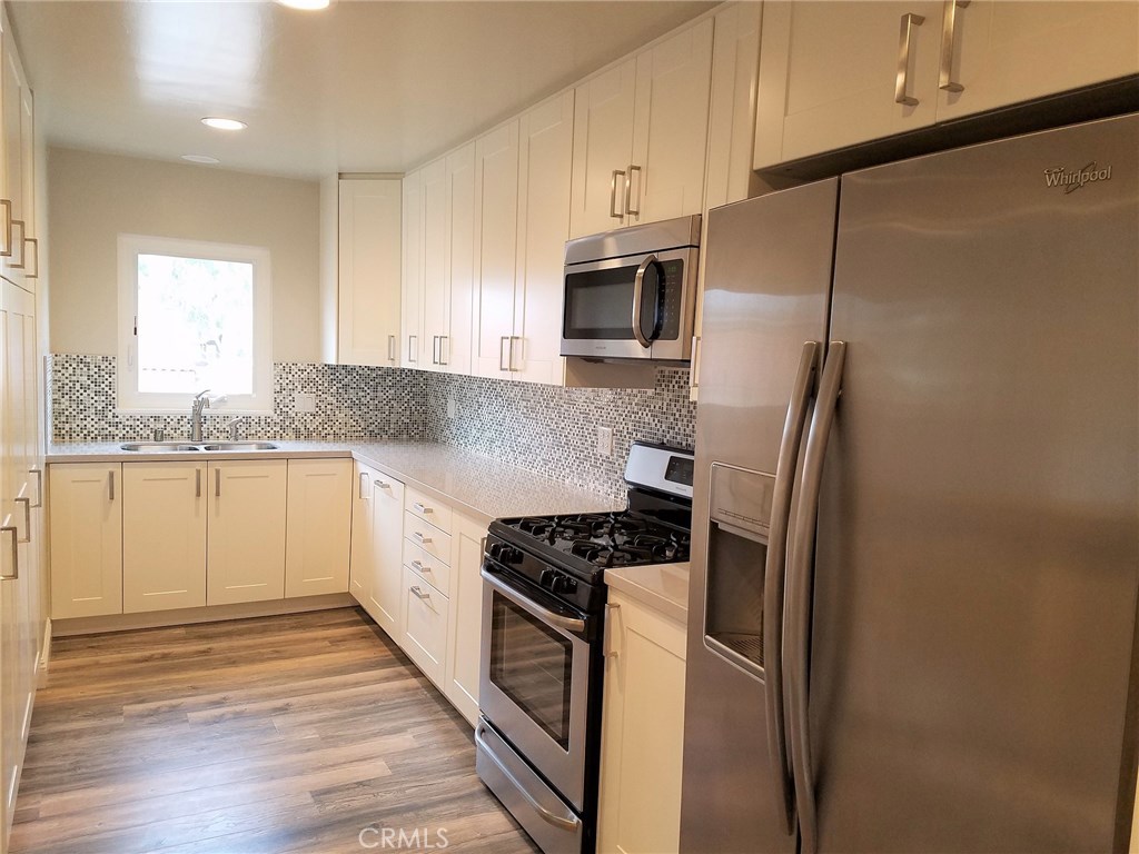 Large gourmet kitchen with stainless steel appliances, hidden panel dishwasher, and 3 full pantries. - 331 3rd Street C, Laguna Beach CA 92651 - photo 1