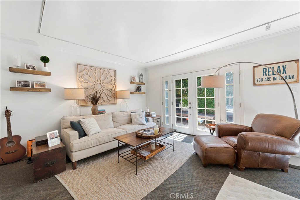 Spacious living room with French doors that open onto a private, peaceful patio. - 356 Y Place lower, Laguna Beach CA 92651 - photo 1