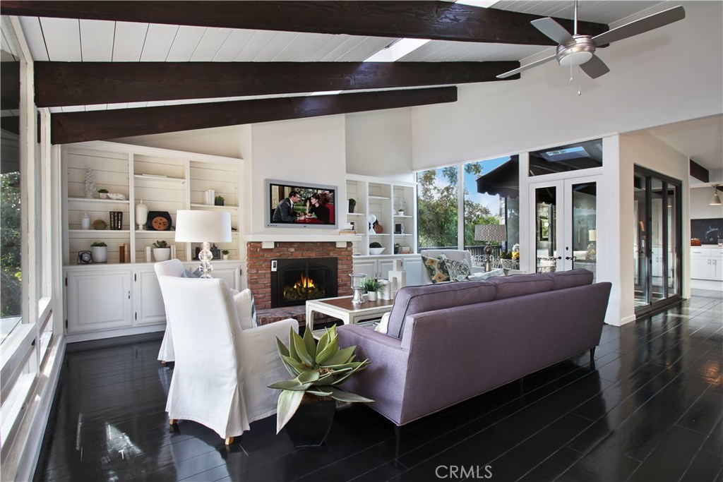 The living room, dining room, kitchen and master suite are on the upper level. The abundance of windows and skylights fi - 444 Flora Street, Laguna Beach CA 92651 - photo 1