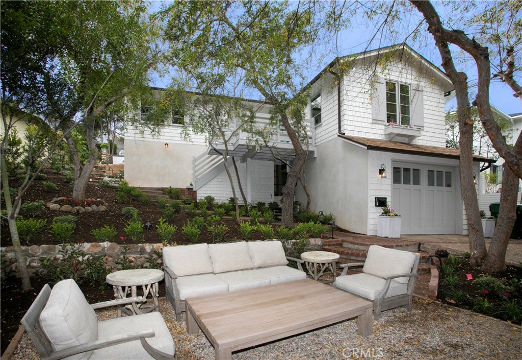 Front of house with deep one car garage, landscaped with seating areas in front and back, vegetable garden planter boxes - 464 El Bosque, Laguna Beach CA 92651 - photo 1